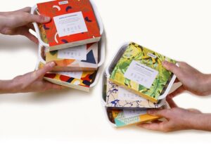 Array of colourfully packaged meals by allplants being displayed