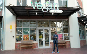 Founder of Vegan Fine Foods standing in front of his store