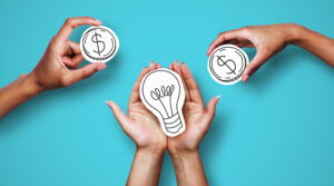 Hands with dollar sign coins and light bulb, against a blue background, representing financing