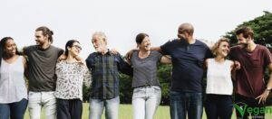 Group of people looking happy hugging arm in arm